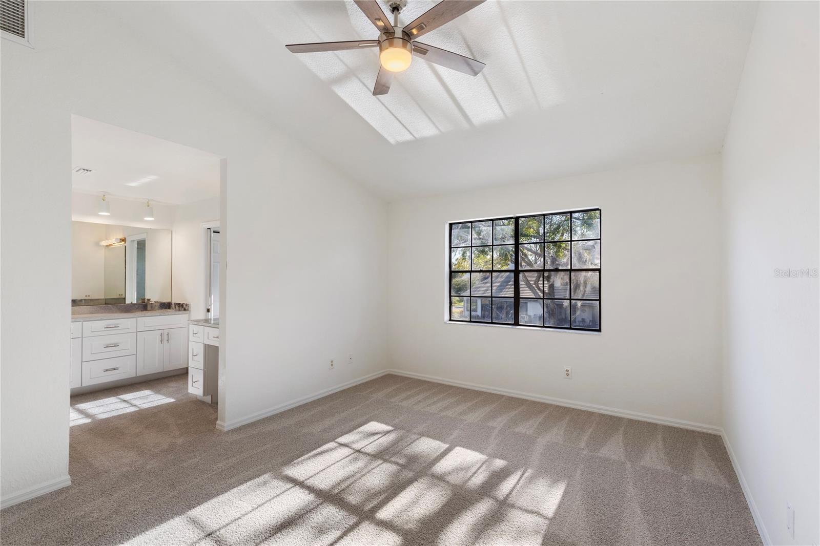 Primary Suite.  A large room with plenty of natural light and a newly renovated ensuite bath