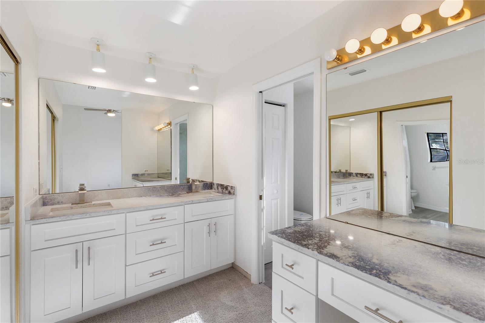 The primary bath with dual sinks and a separate makeup area.