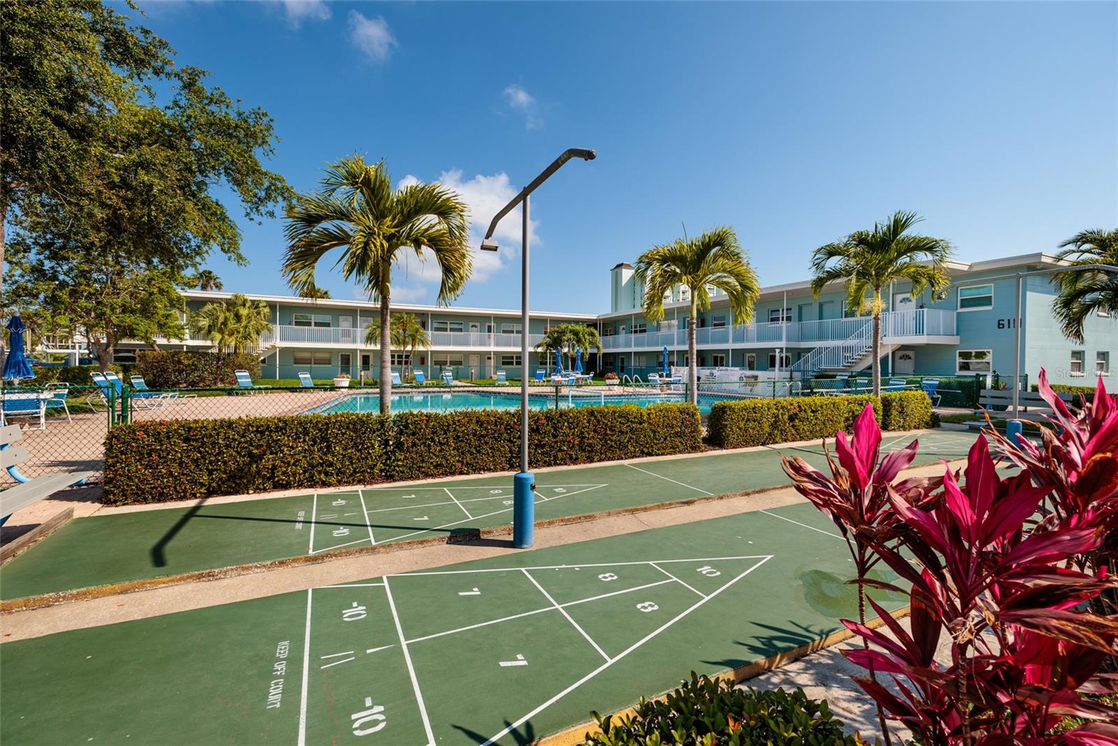 Shuffleboard courts in grilling area across from unit.