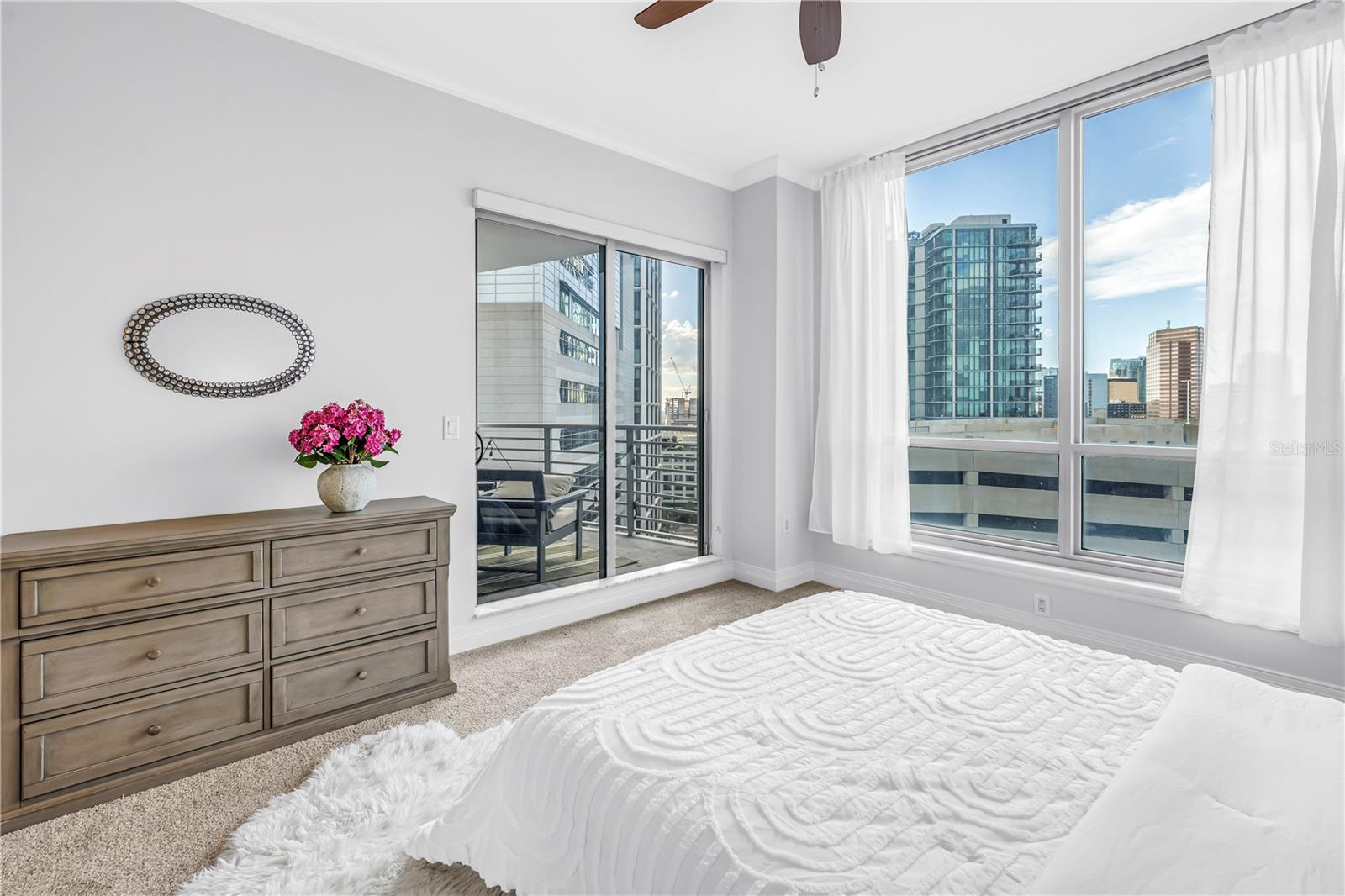 Right Primary Suite with Sliders to the Balcony and Downtown Views