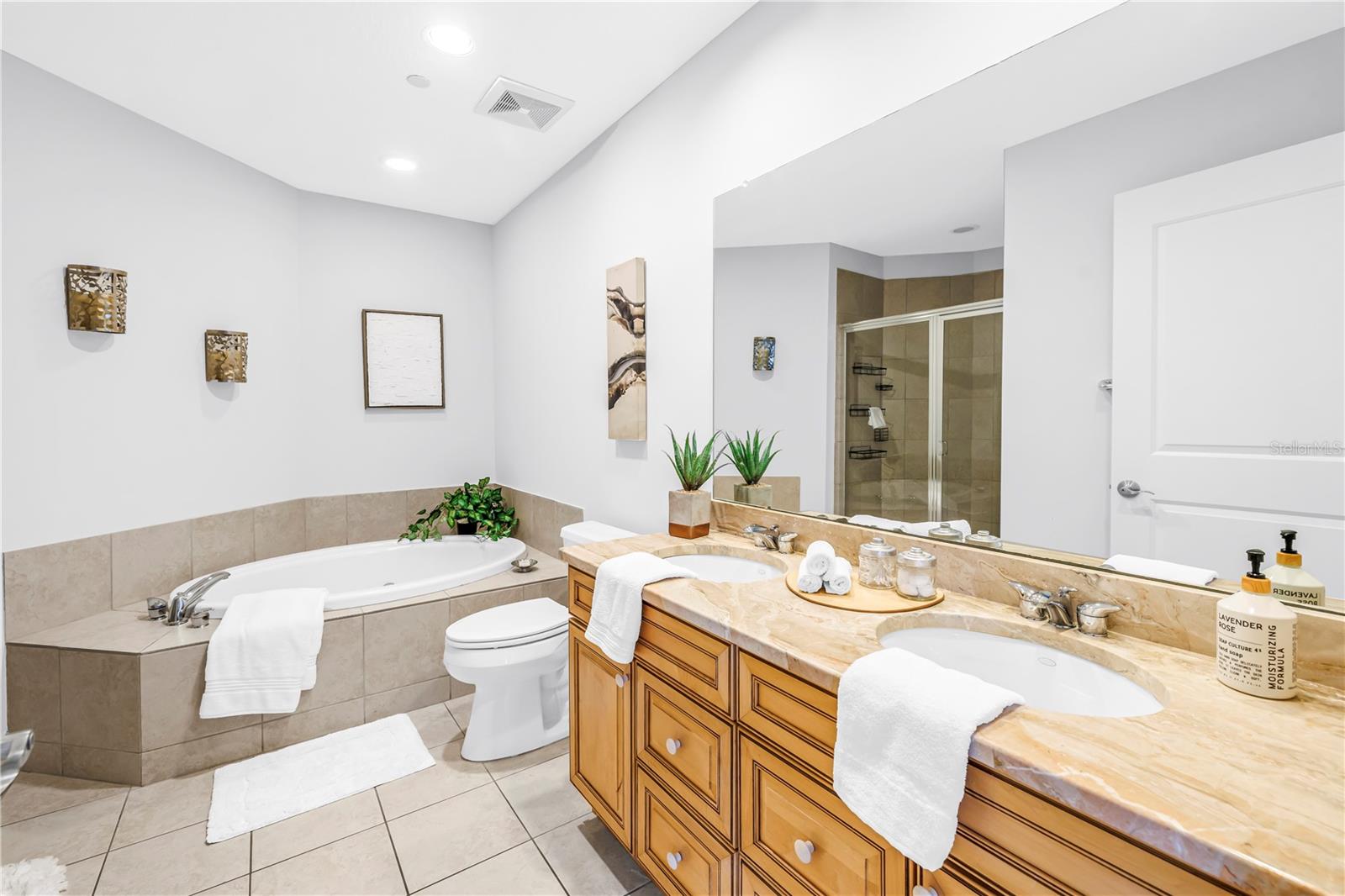 Right Primary Garden Tub and Dual Granite Vanity.  Notice the Large Walk-In Shower Image