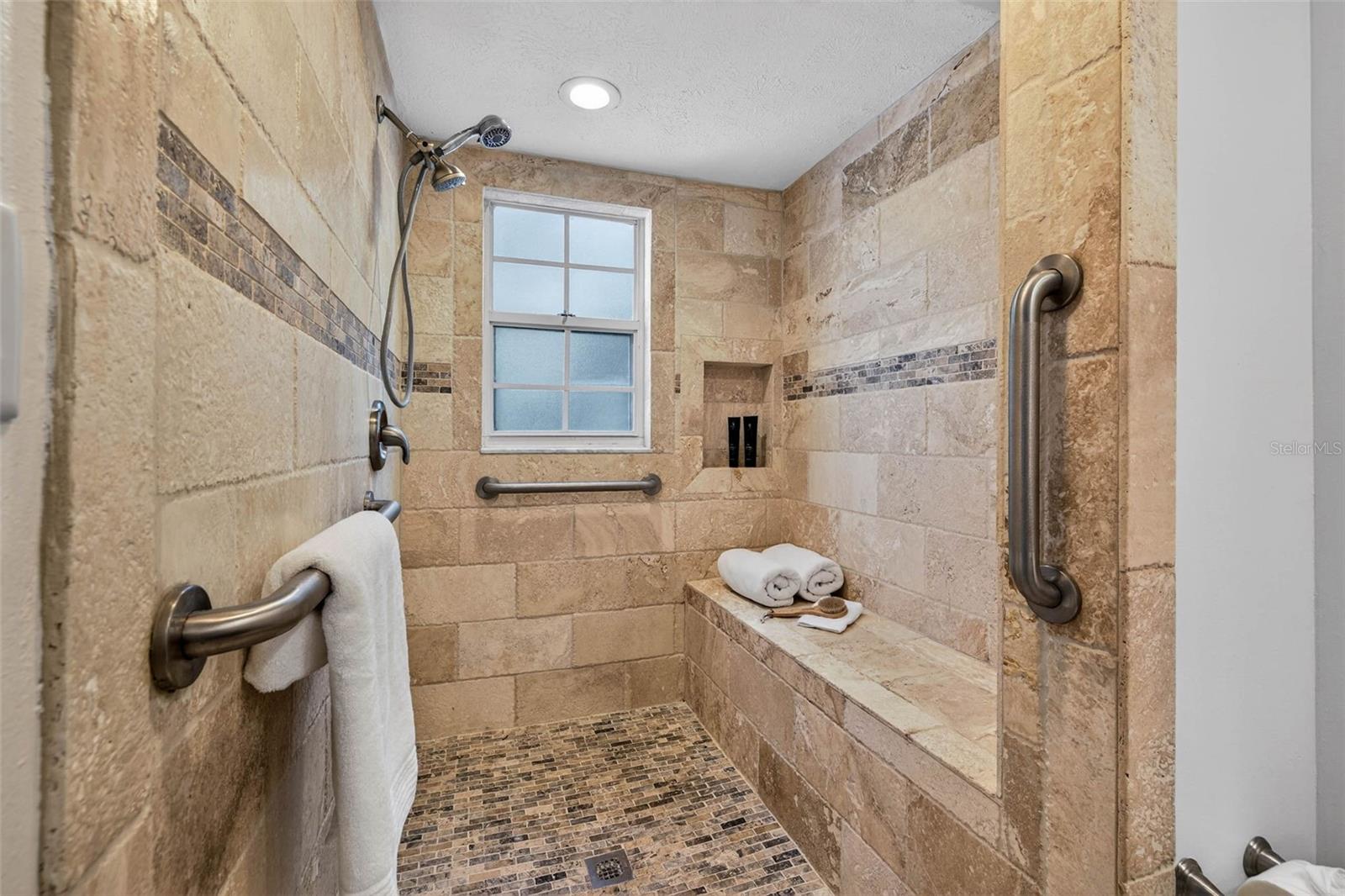 Large walk-in shower w/roomy  built-in bench...& no glass to clean!