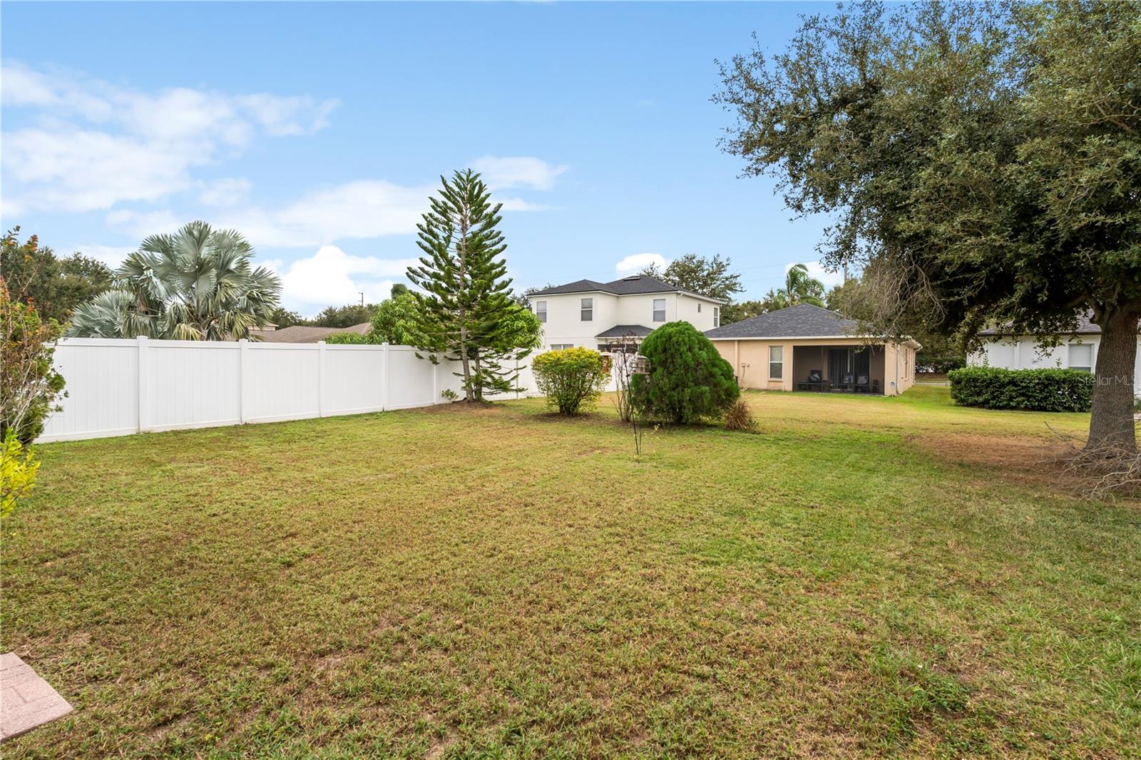 Expansive backyard with plenty of room to relax, play, or enjoy Florida outdoor living in a private setting.
