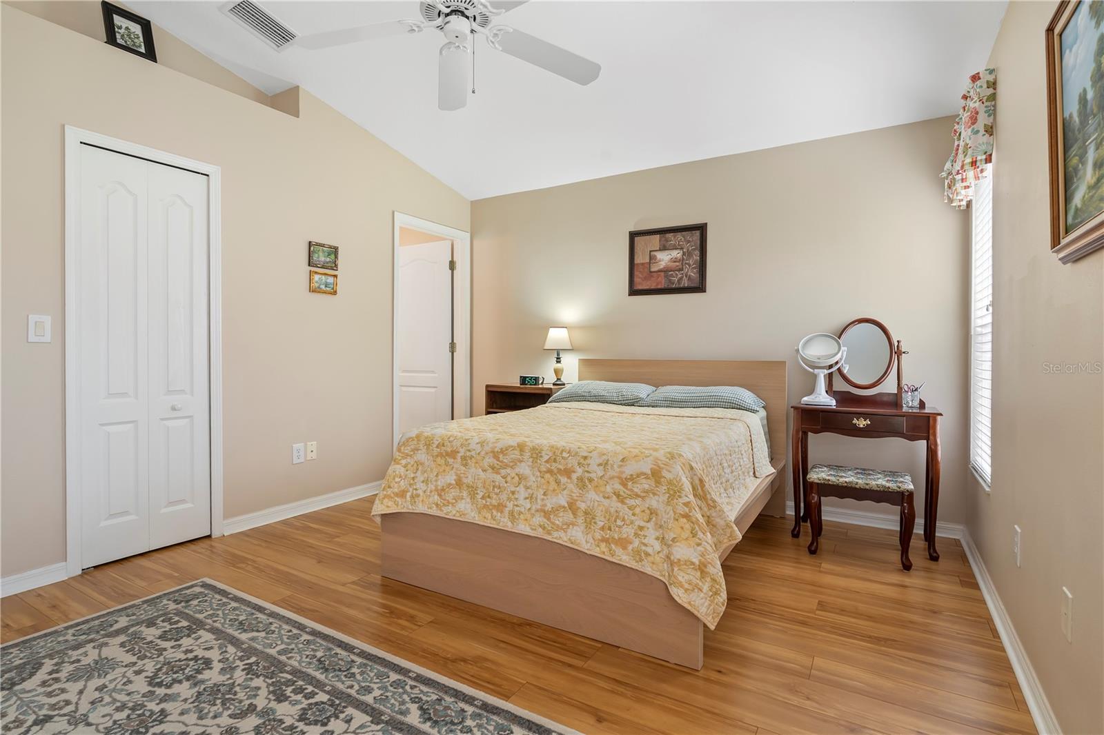 Comfortable primary bedroom with natural light and a peaceful atmosphere designed for rest and relaxation.