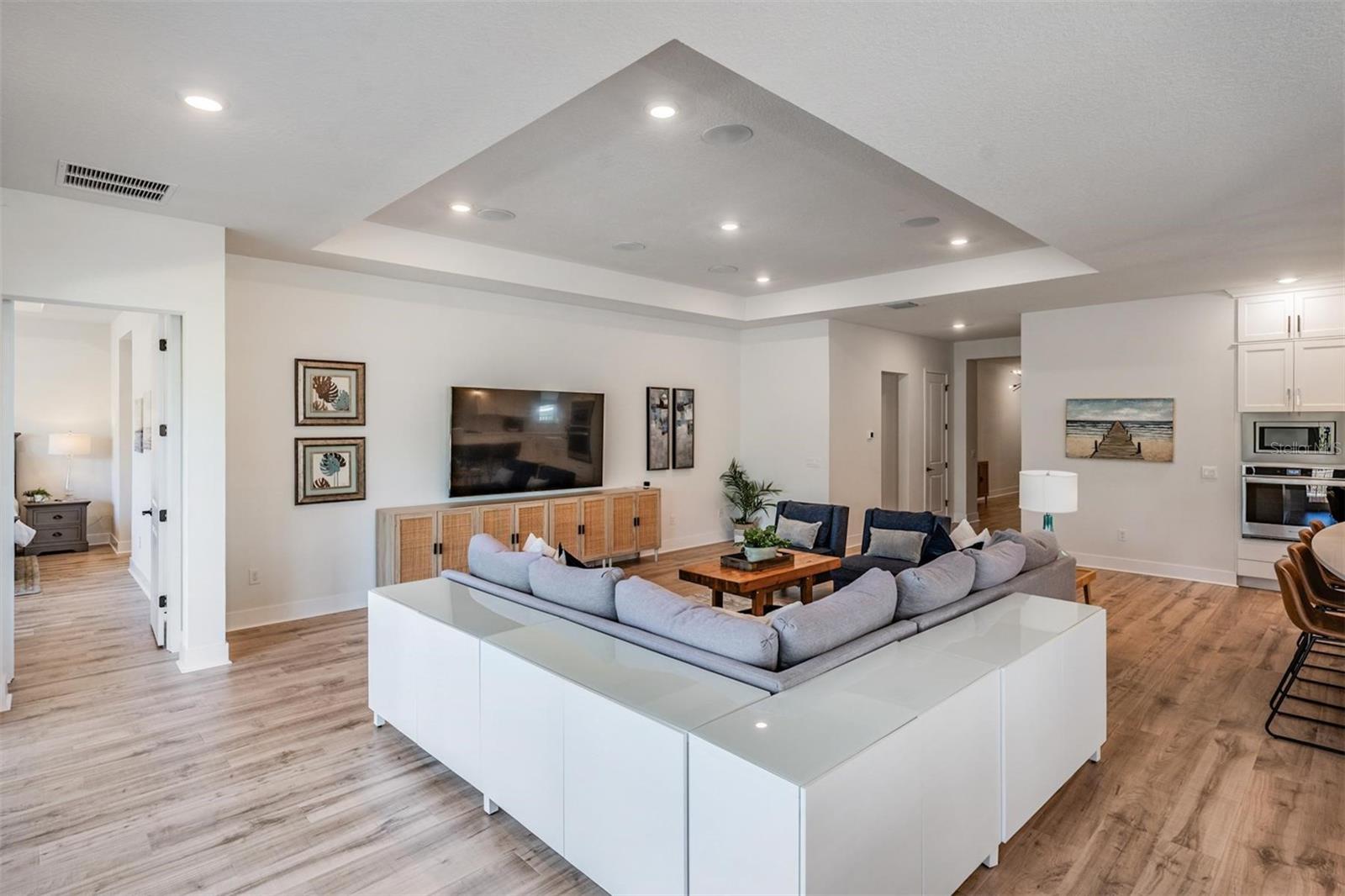 Great room with recessed lighting and trey ceiling element