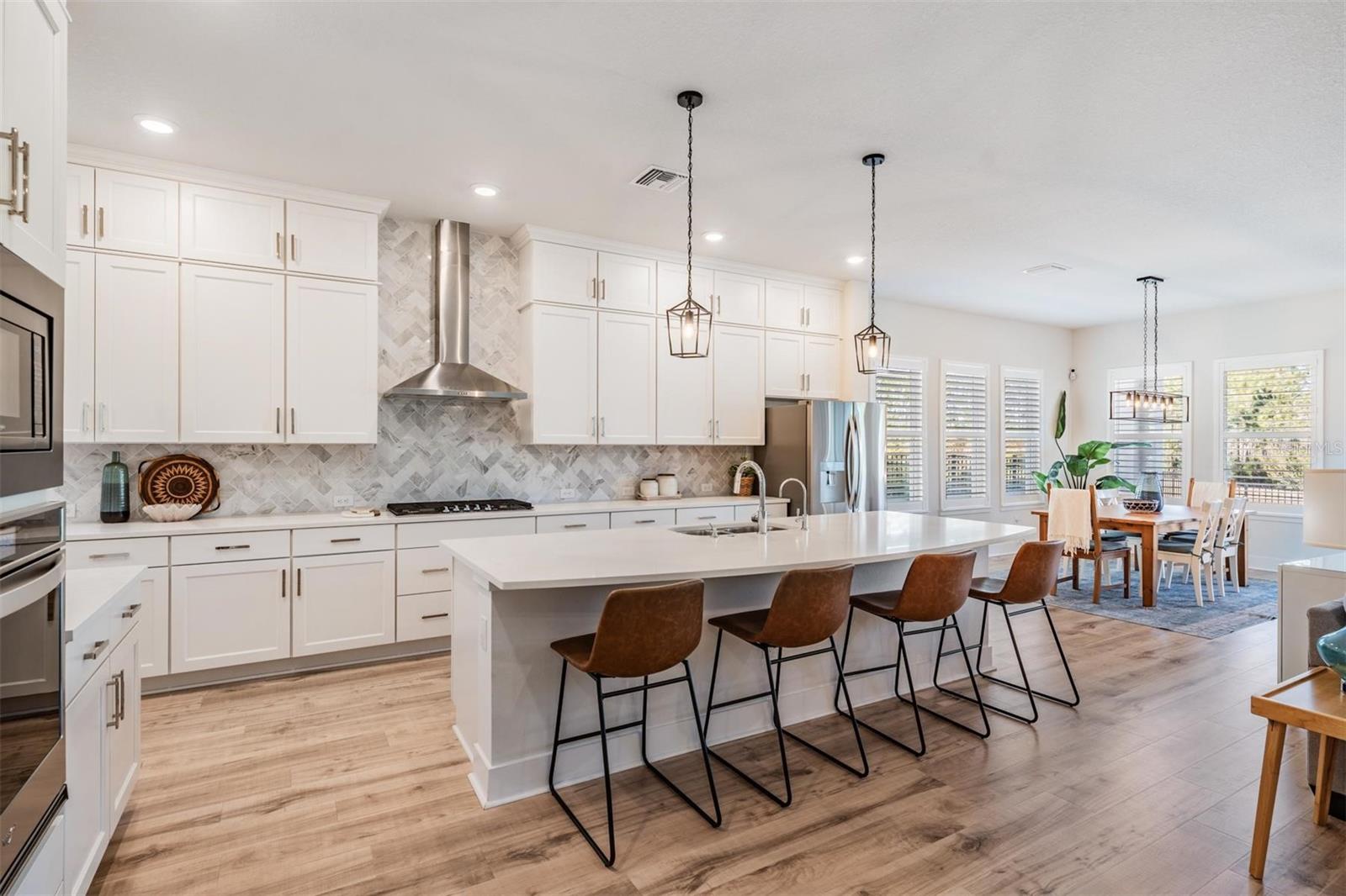 Light and bright with pendant lighting over the island/breakfast bar