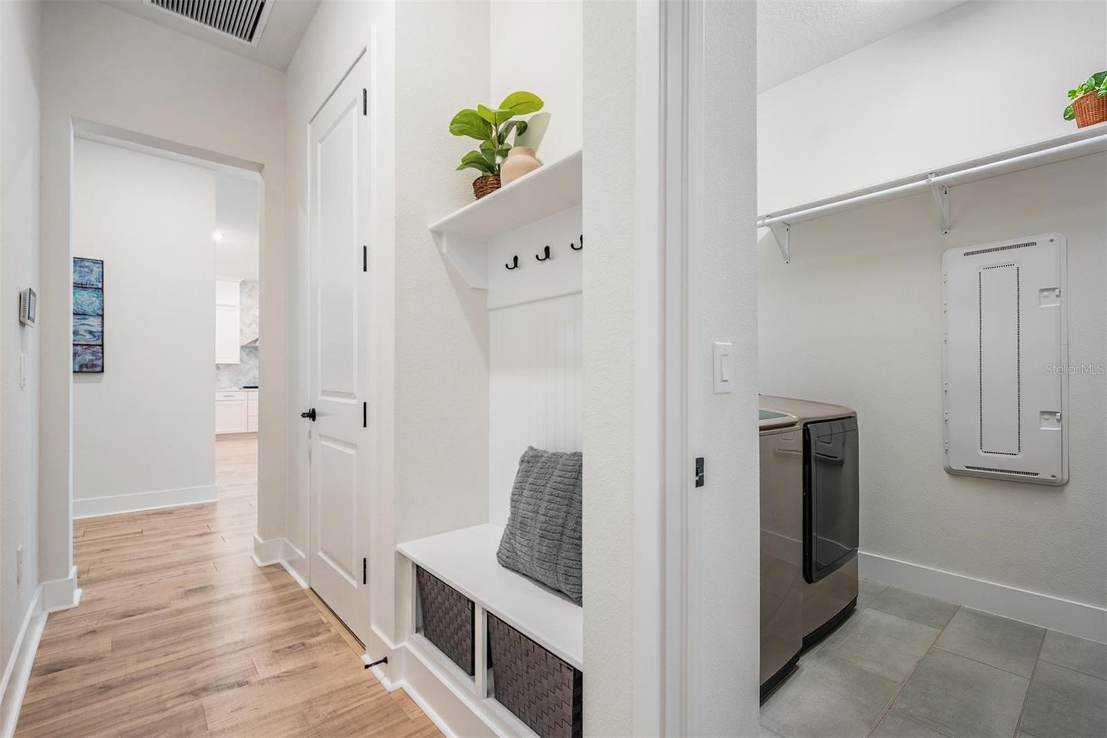 Laundry area and thoughtful built-ins for coats and backpacks