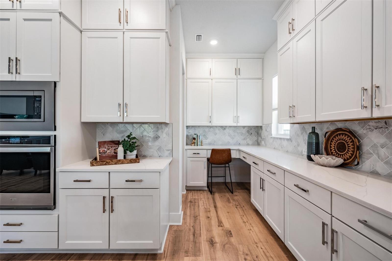 Thoughtful kitchen layout includes a "home command center" in the Butler's pantry area