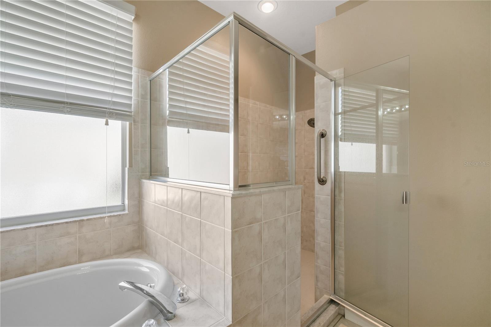 Buyers will enjoy the separate soaking tub and shower with safety bars and an enclosed water closet with a chair level toilet recently installed.