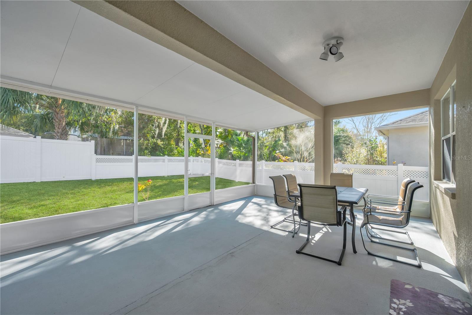 The patio overlooks a private, fenced backyard—an ideal setting for peaceful evenings or weekend get-togethers.