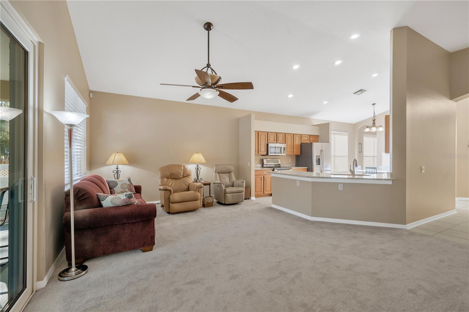 The open-concept kitchen flows effortlessly into the living room, with a breakfast bar providing both separation and functionality.