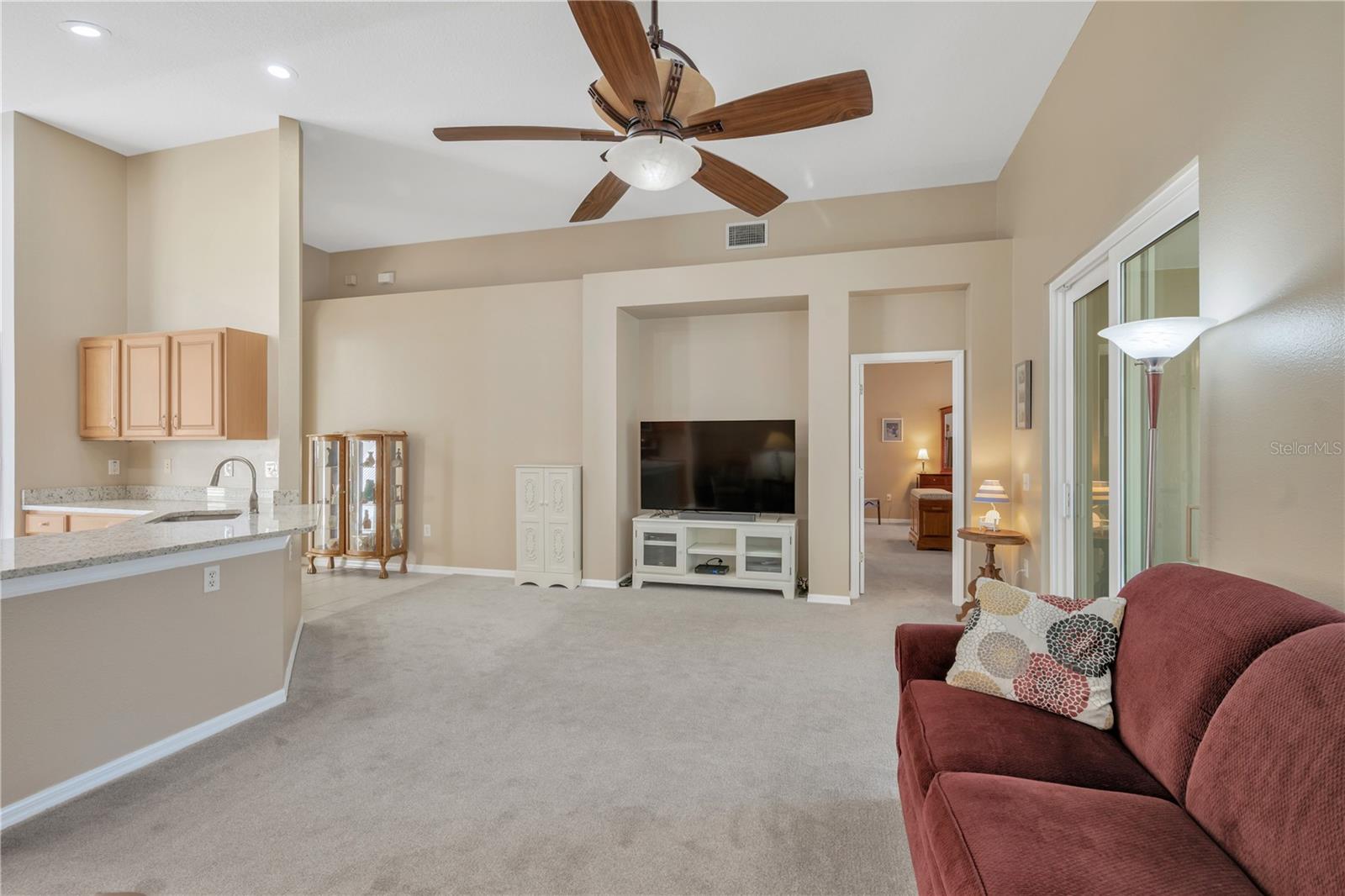 The living room is enhanced by dramatic cathedral ceilings, creating a bright and open feel.