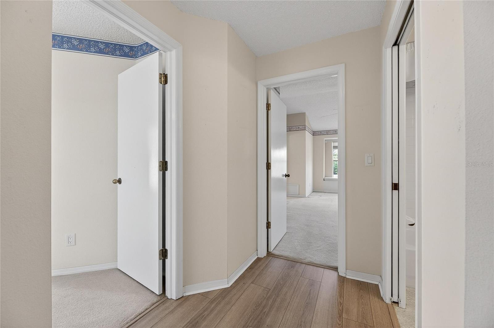 Entryway to 2nd bedroom and primary suite