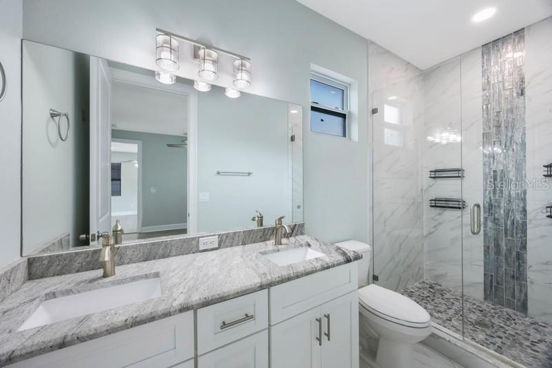 Primary bathroom: Dual sinks and granite countertops