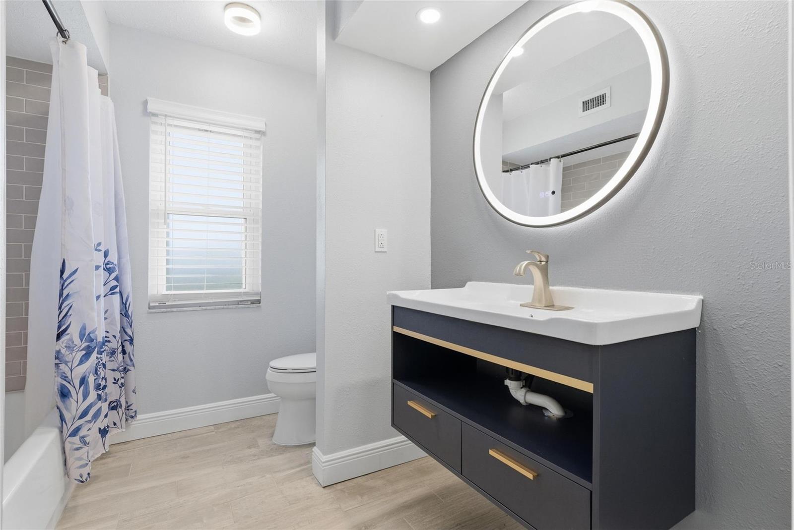 Renovated full bath with smart mirror