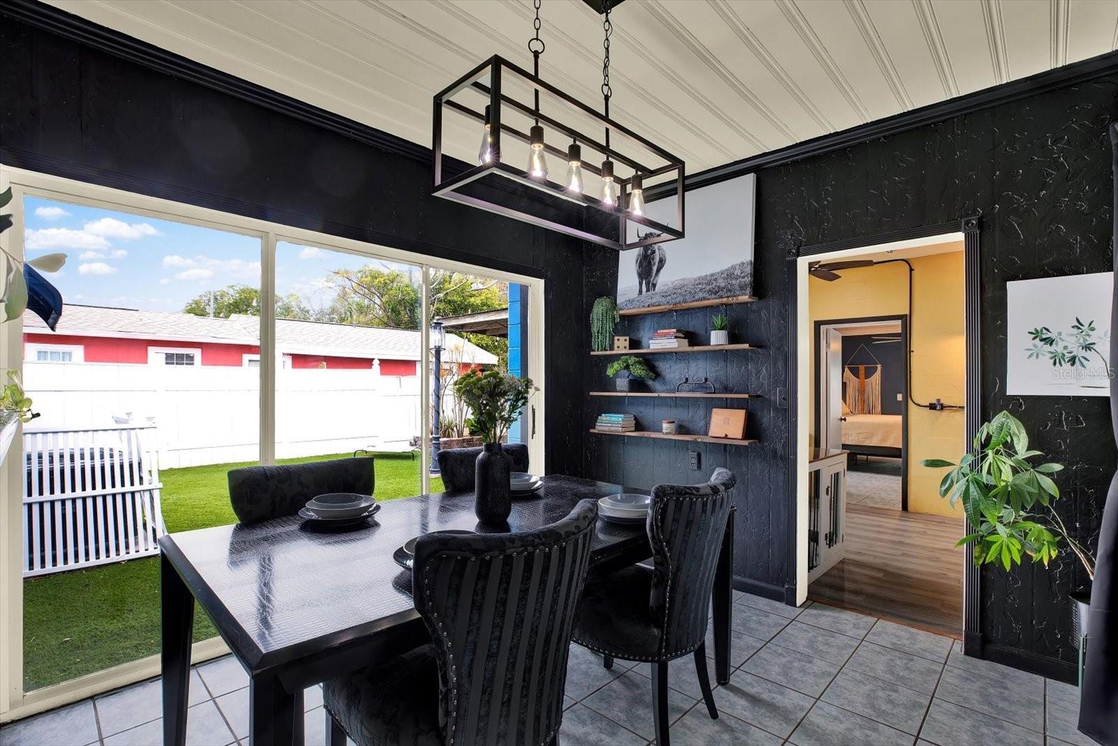 Triple Slider Doors in Dining Room Lead to the Backyard