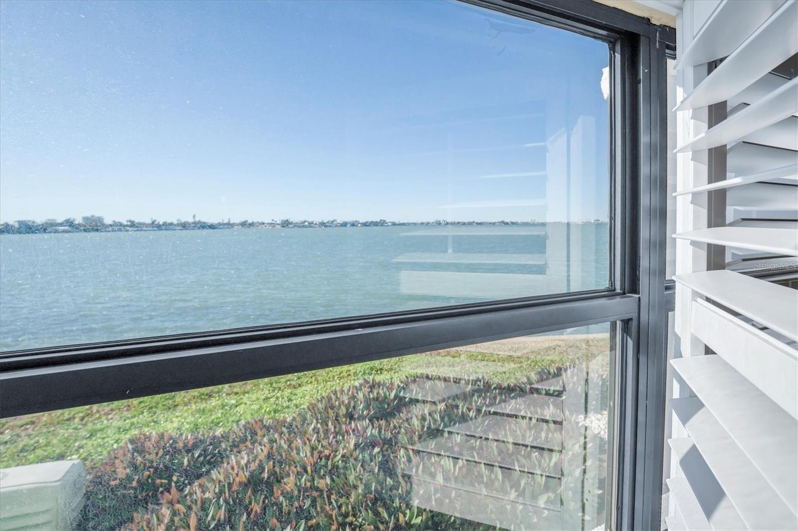 Gorgeous view of the Bay from master bedroom window with coastal plantation shutters