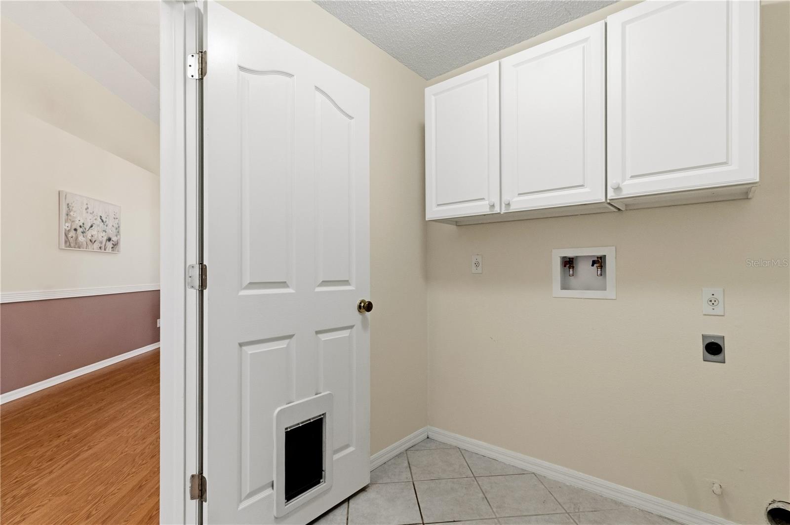 Laundry room with hookups for gas and electric dryers