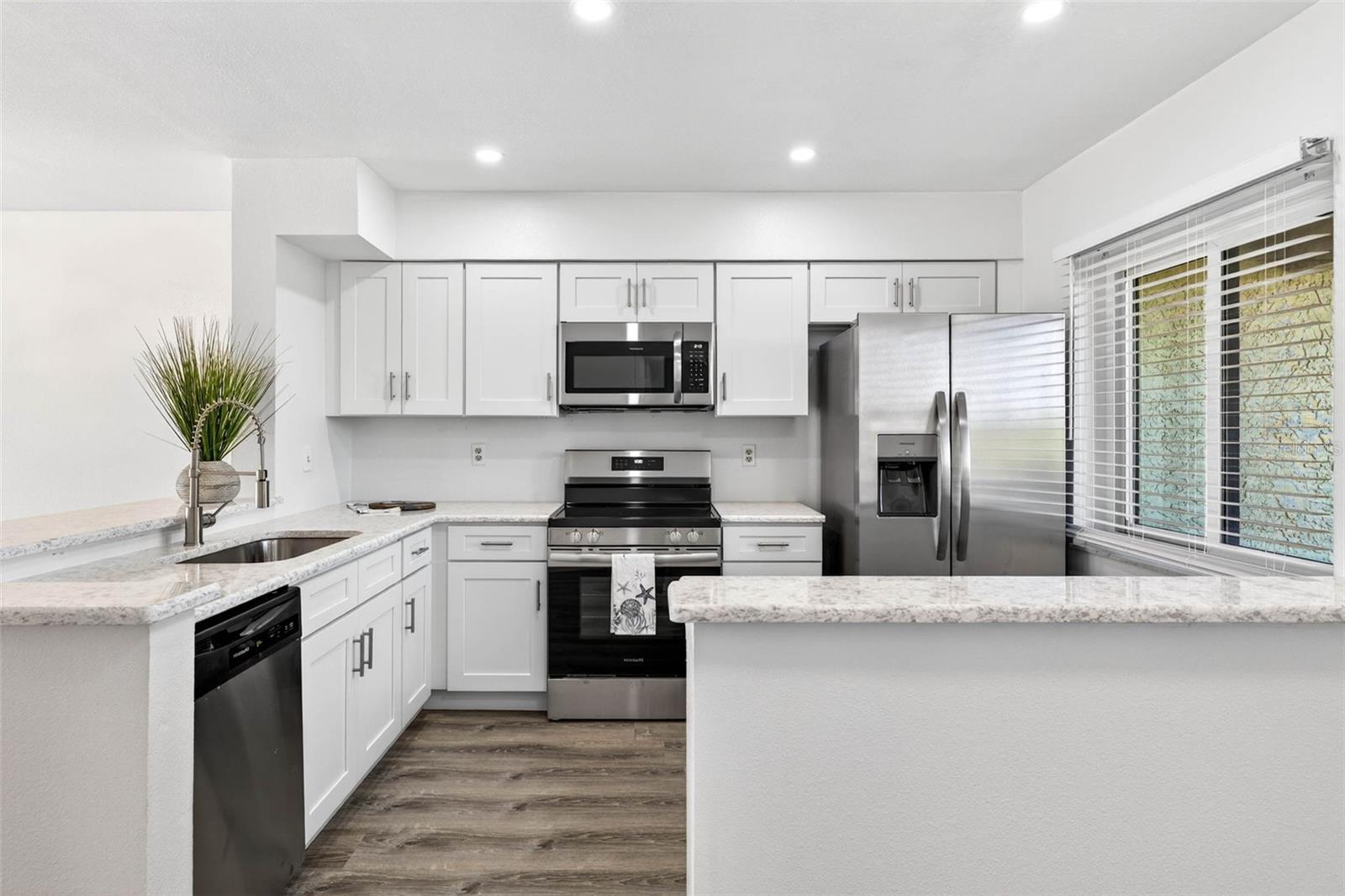 Soft-close cabinets, quartz counters, stainless appliances, and a beverage station. Designed for cooking and entertaining.