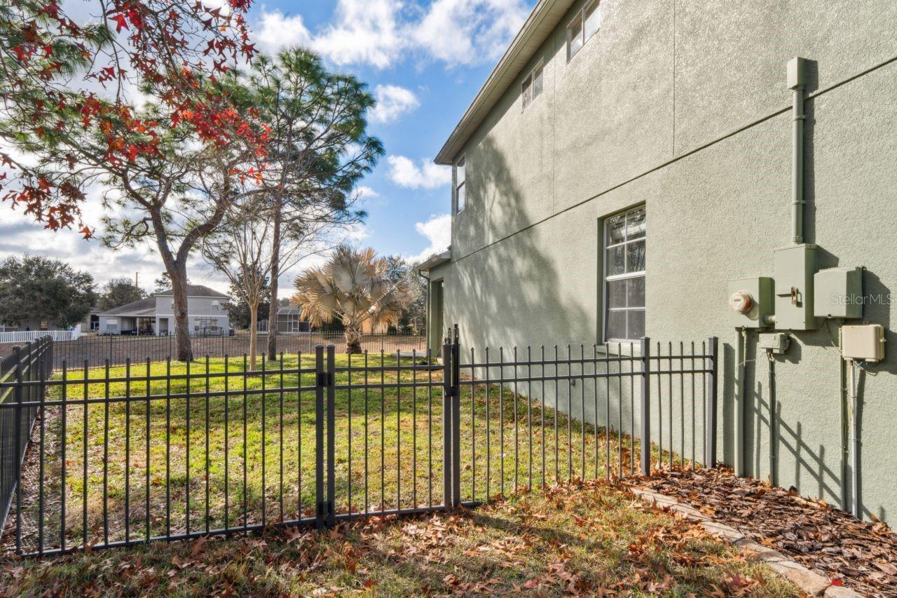 gate w/ lock left side of home