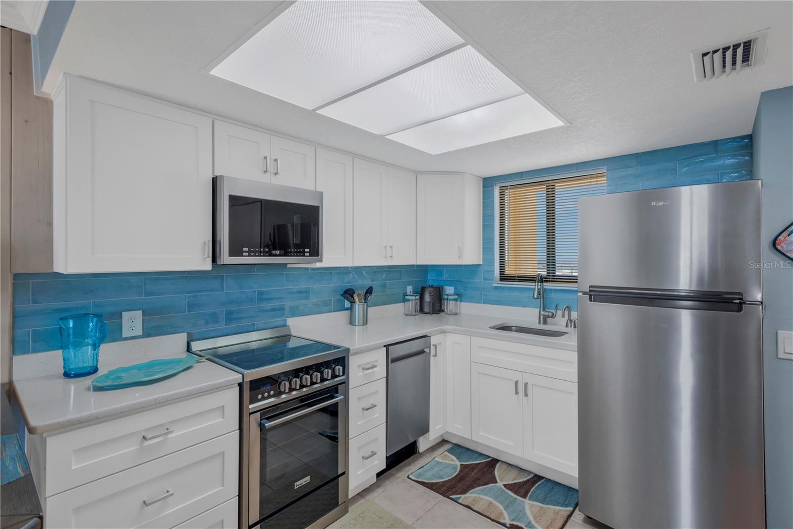 Enjoy preparing those amazing menus in this updated stylish kitchen.  Stainless steel appliances, lovely accent backsplash adds a sparkle of color and you even have a window that allows in natural light as well as views of the canal waters.