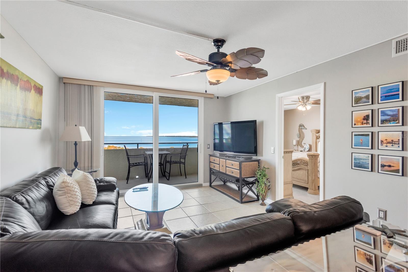 Another view of living room, open air covered patio and glimpse of Master Suite off to your right.