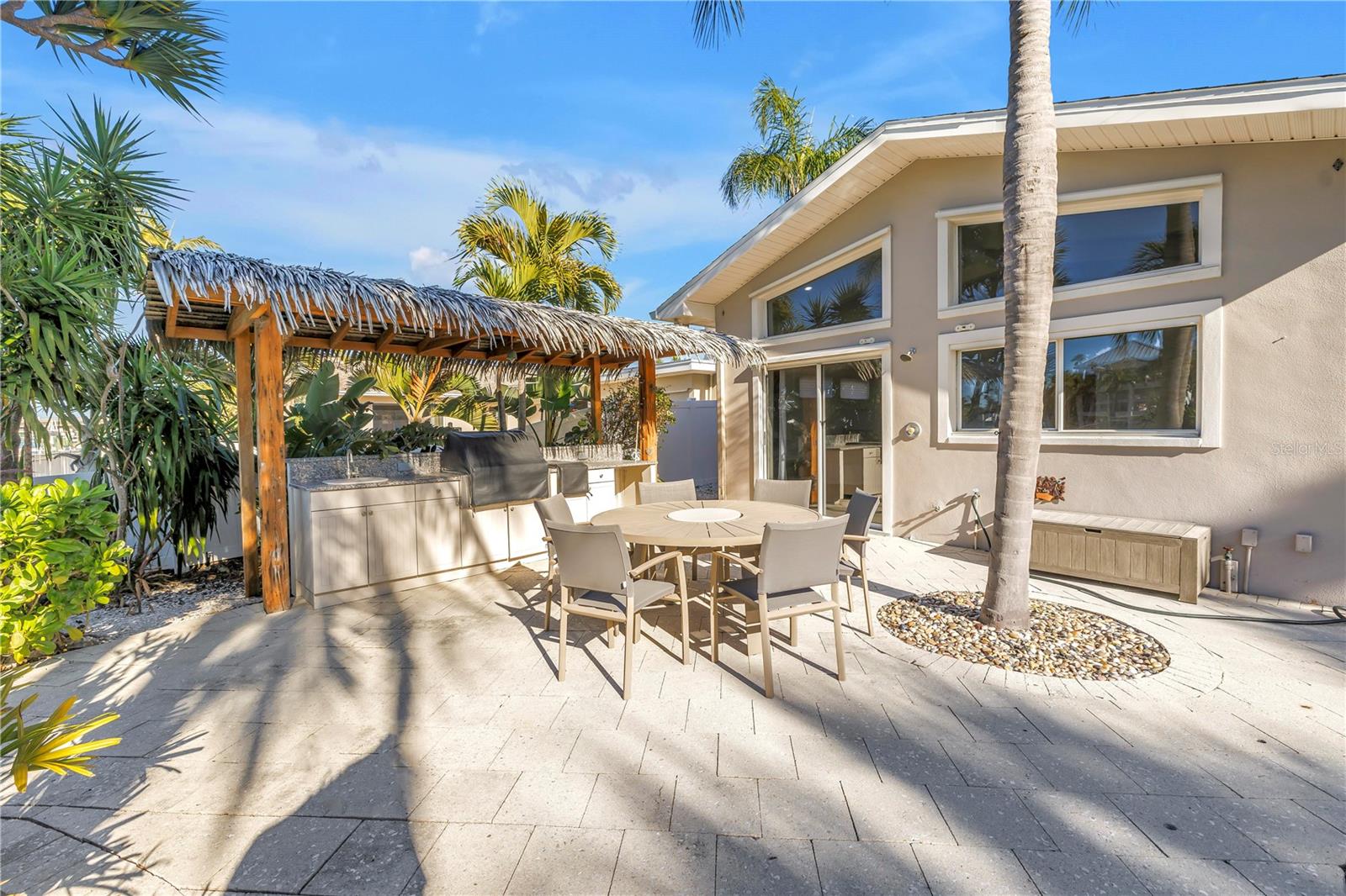 Outdoor Tiki hut style BBQ, sink with waterfront dining