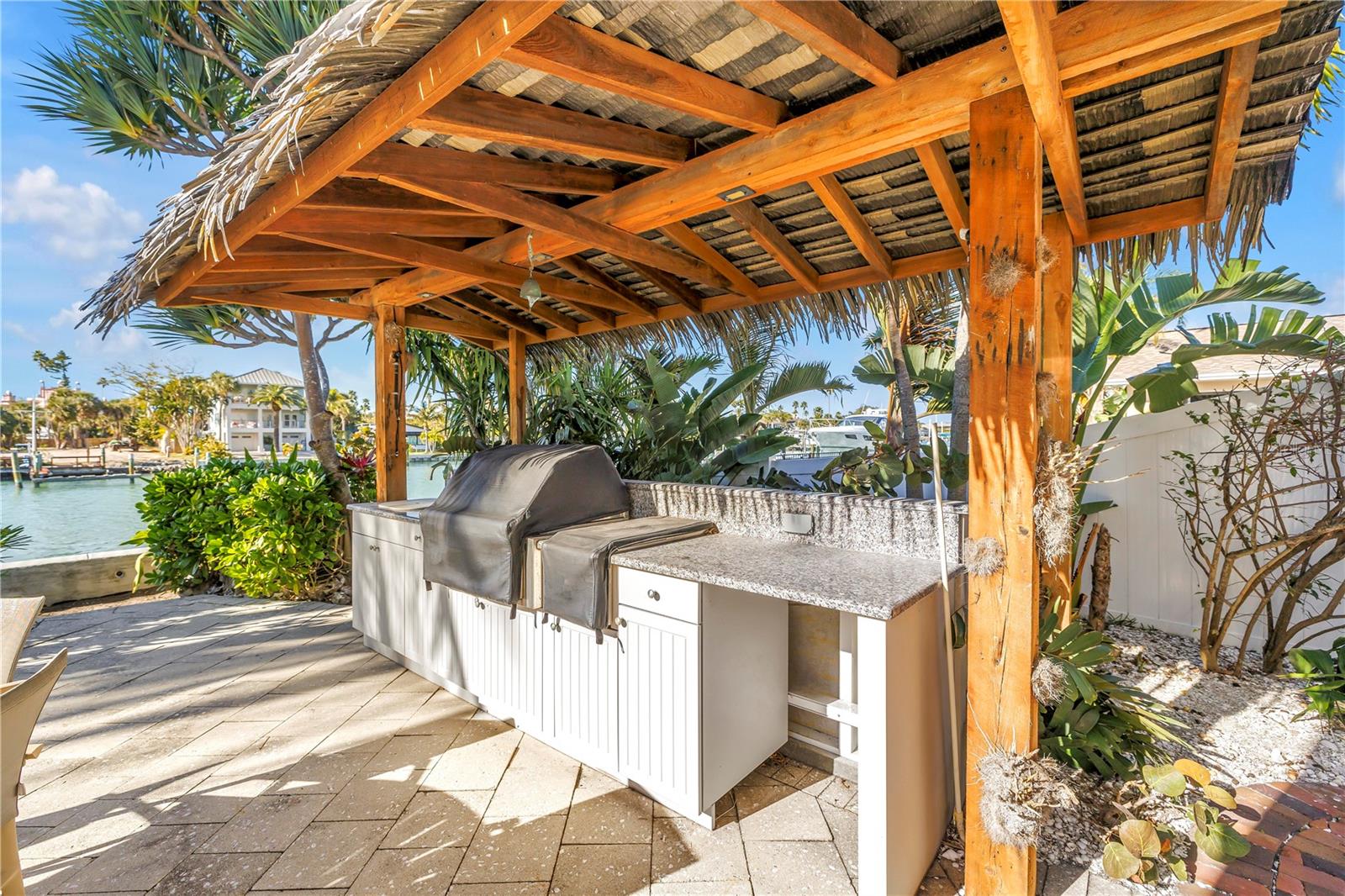 Outdoor Tiki hut style BBQ, sink with waterfront dining