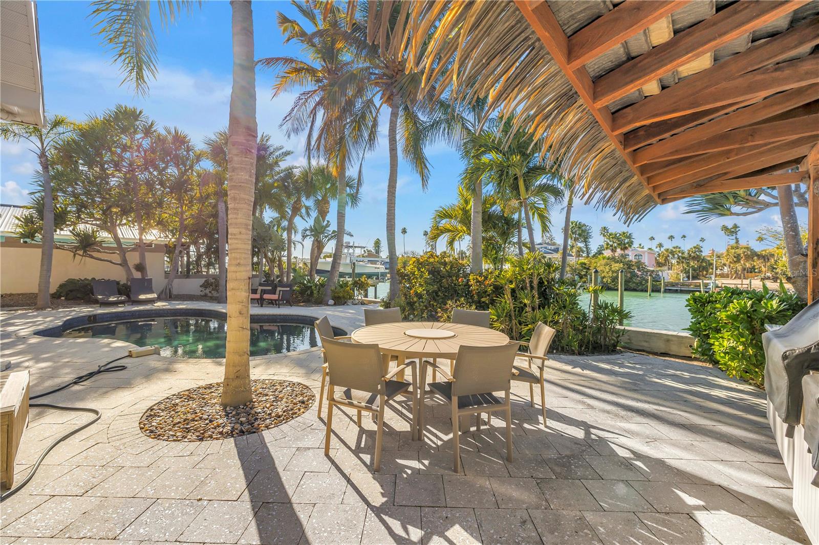 Outdoor Tiki hut style BBQ, sink with waterfront dining