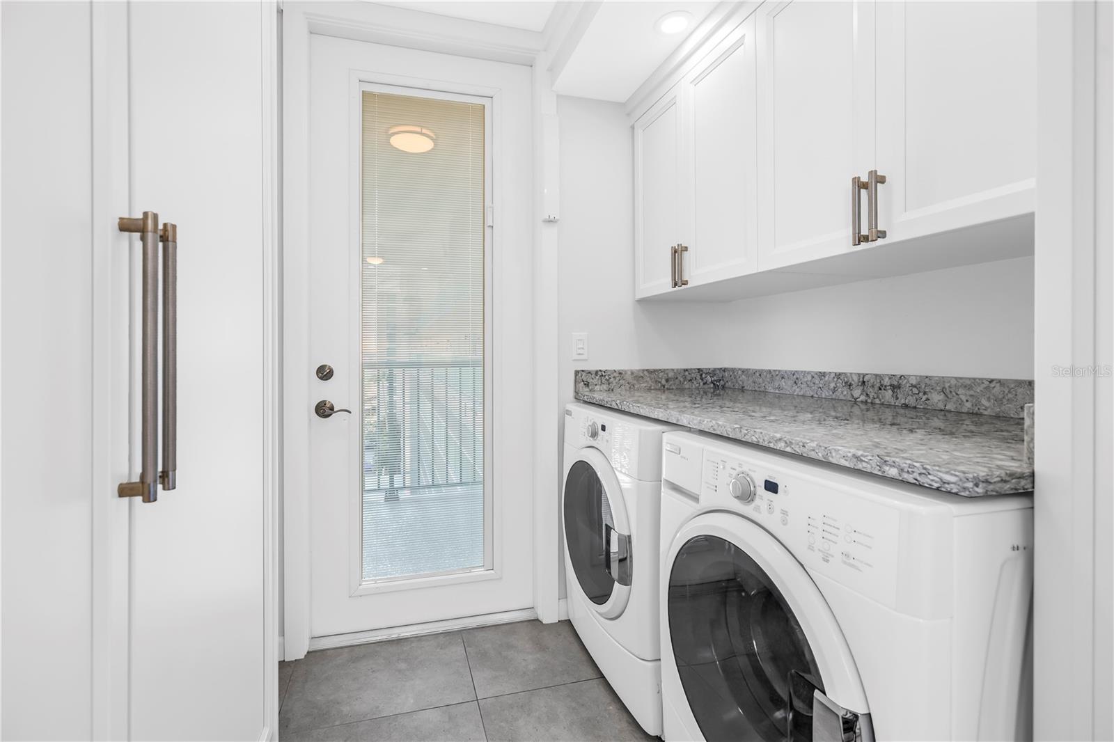 Washer and Dryer tucked away off kitchen