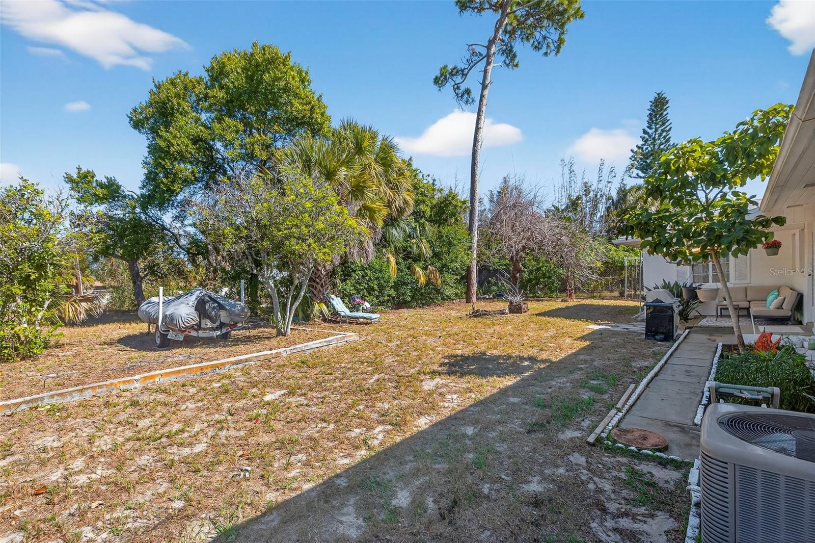 the backyard provides plenty of room for gatherings, play, or creating your own private retreat.