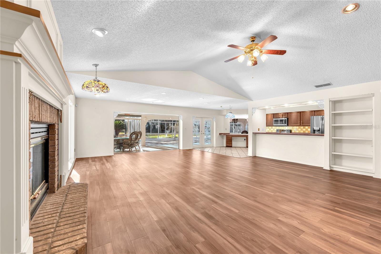View of the family room from the wood burning fireplace shows how large this room is.