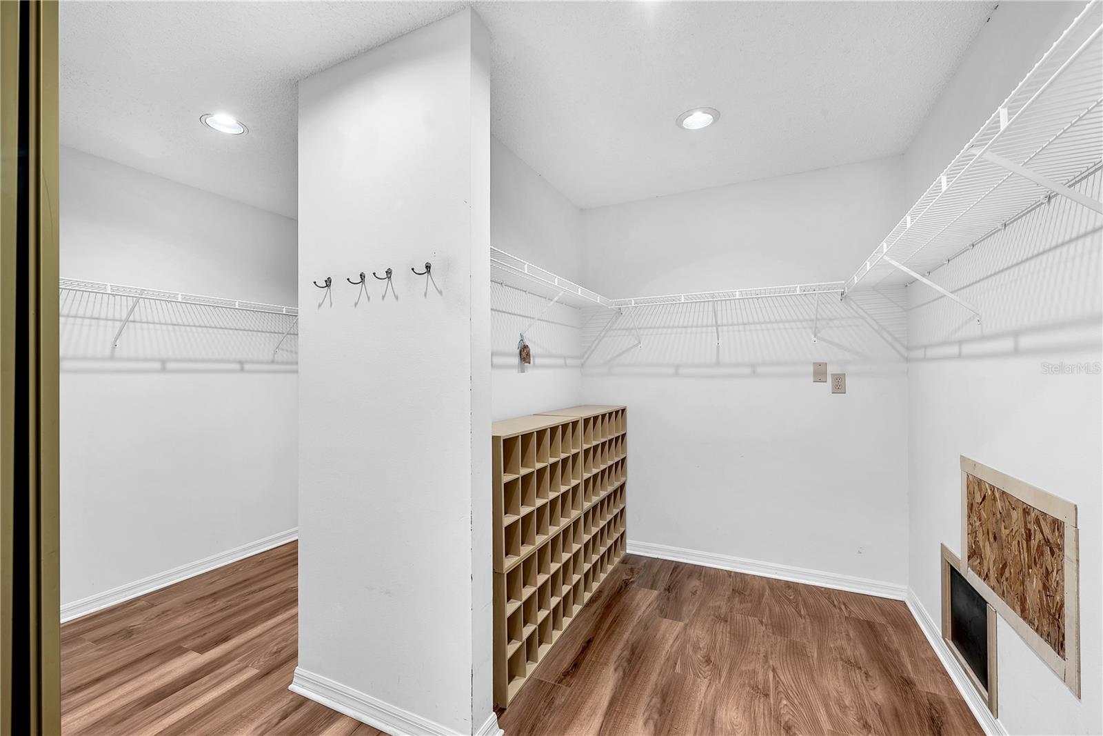 This room-sized walk-in closet offers ample space to organize your wardrobe, with built-in shoe storage designed to accommodate even the most extensive footwear collection.