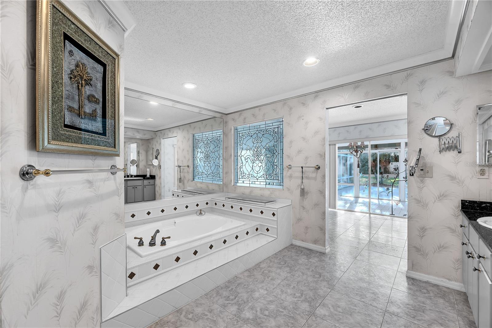 The leaded glass continues from the front door into the owner's ensuite above the bathtub.