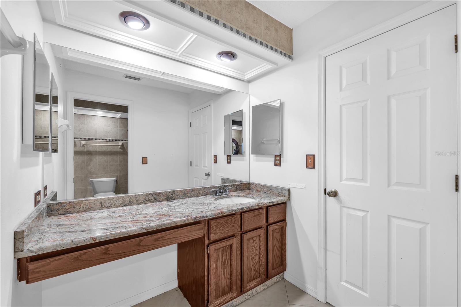 There is an additional sink/vanity room separated from the Jack-and-Jill bathroom for convenience.