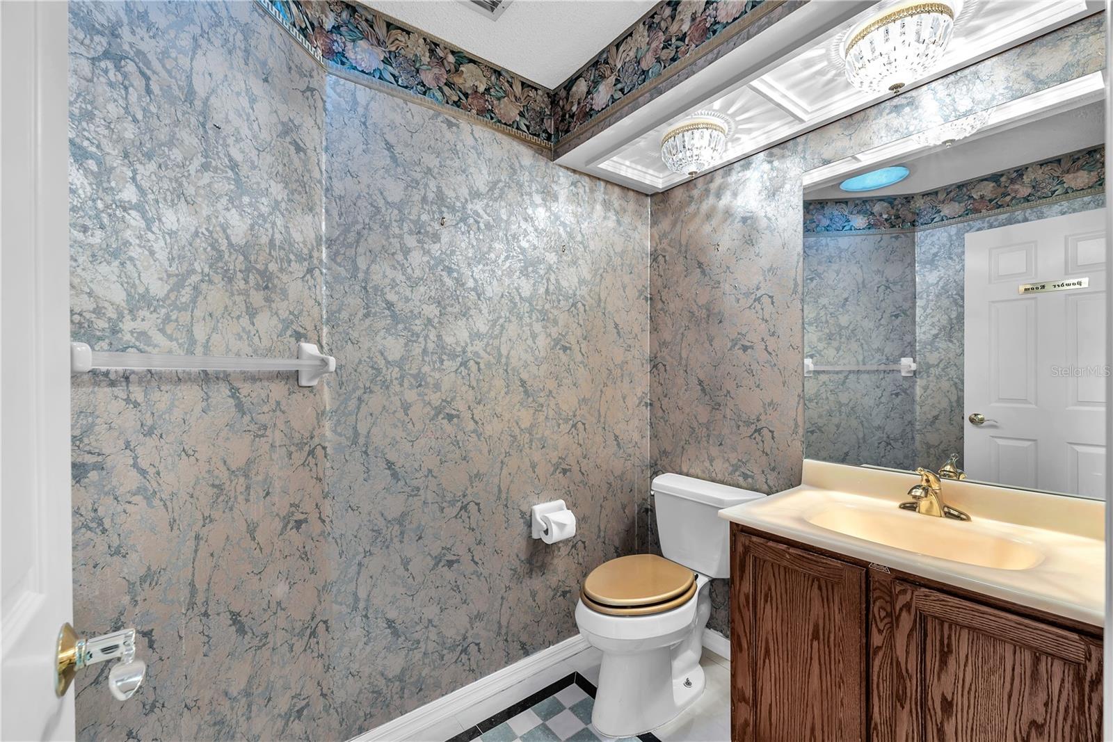 Half bathroom just off the kitchen & pass-through utility room.