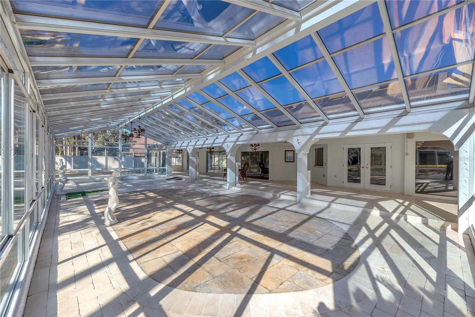 The former pool area has been professionally filled in and finished with marble pavers.