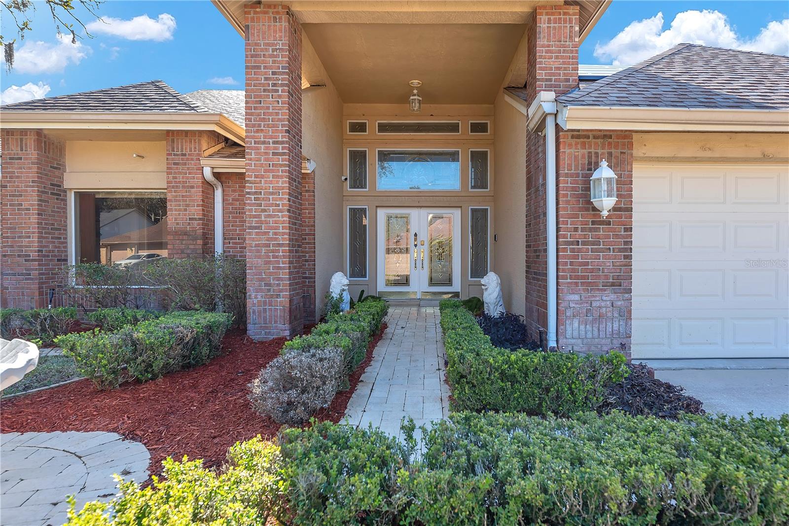 Buyers will love this elegant double-door entry with leaded glass sidelights and double transom details above.