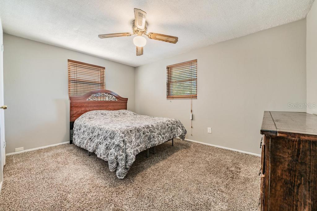 Primary Bedroom with ceiling fan and light fixture.