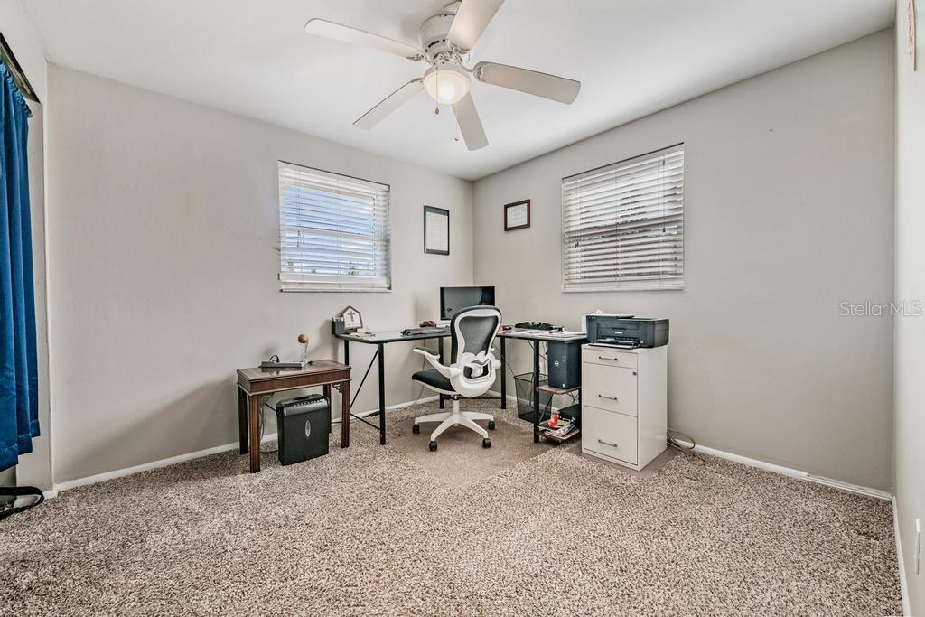 Guest bedroom the that owner uses as an office, ceiling fan/light fixture.