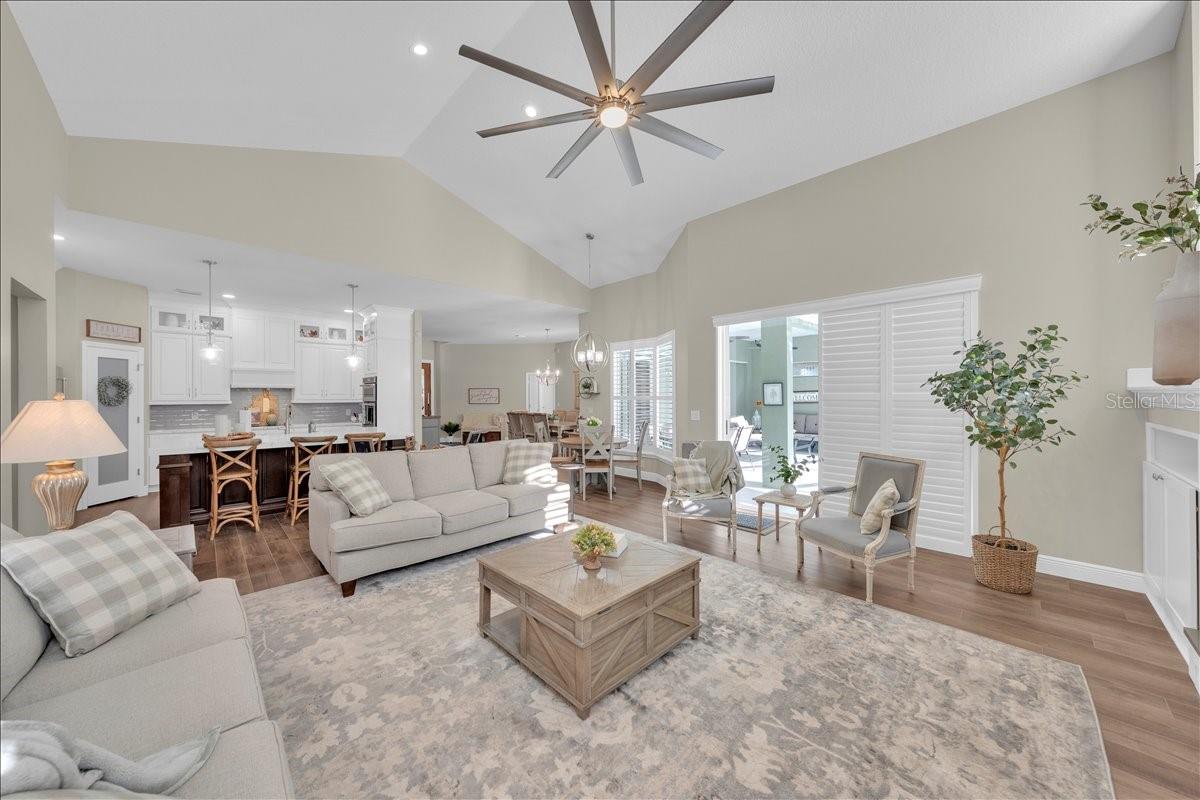 Open-concept living room with coveted neutral paint palette and bright plantation shutters!