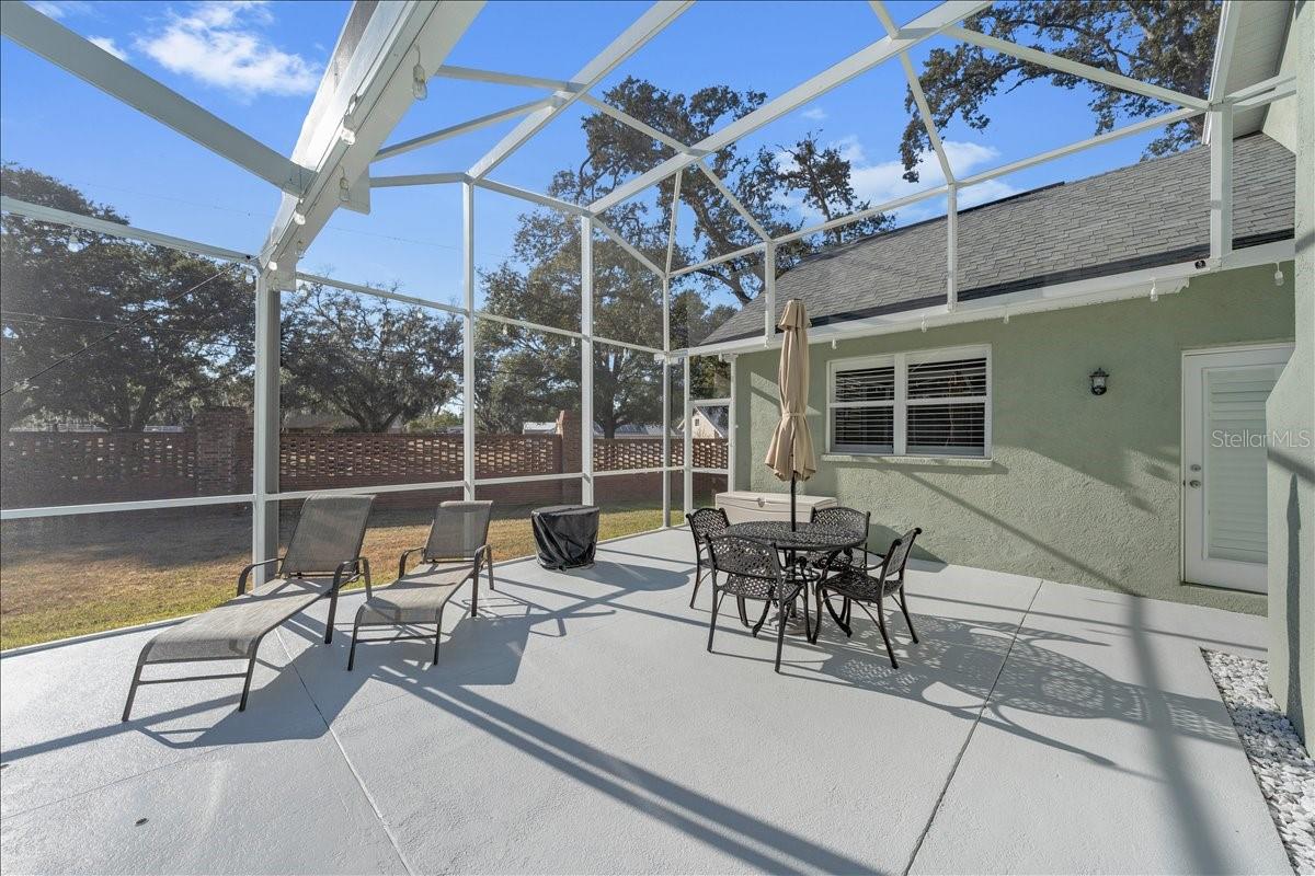 Sun-filled lanai area with backyard views, and easy outdoor entertaining space!