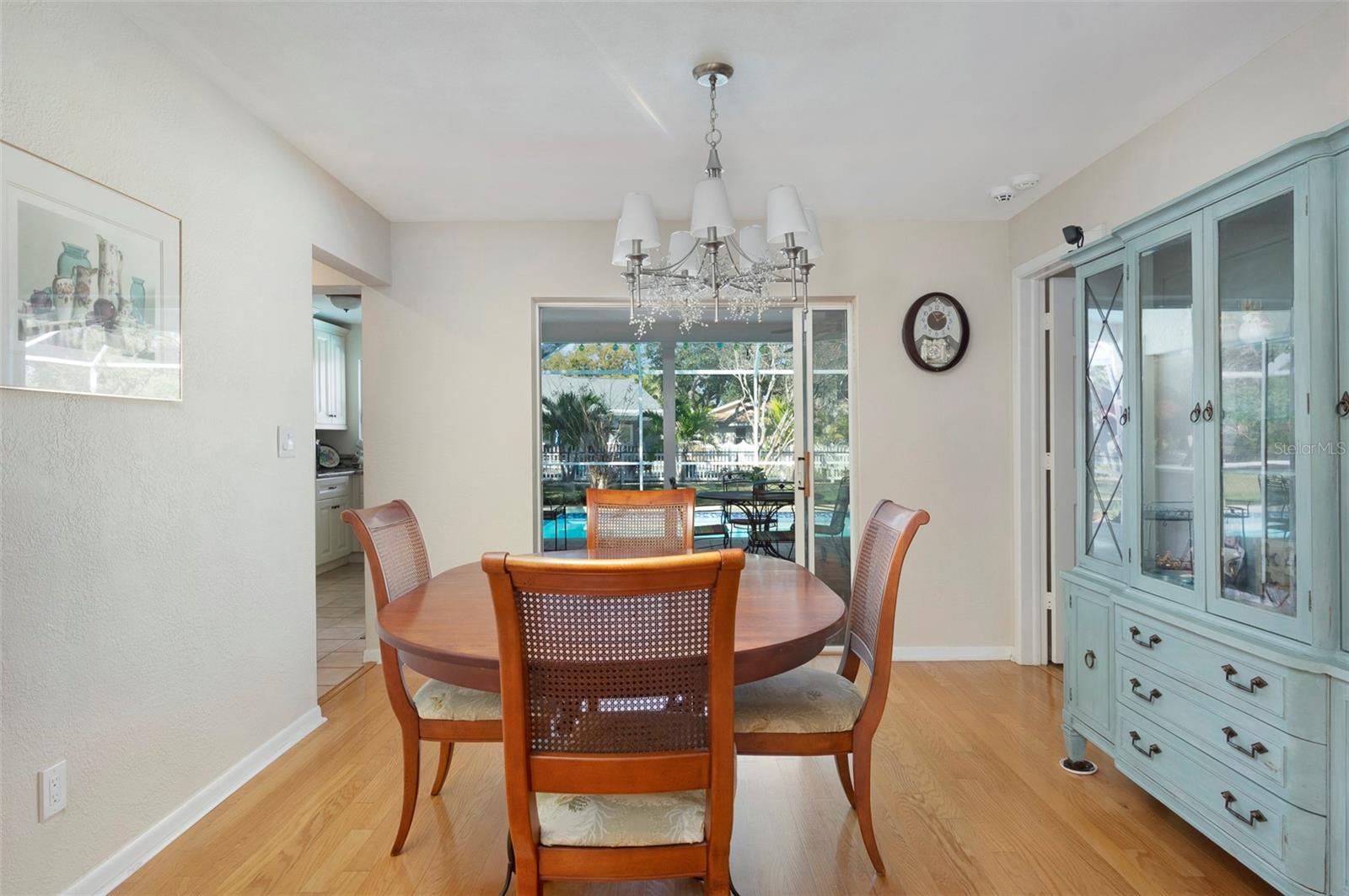 FORMAL DINING ROOM WITH POCKET SLIDING GLASS DOORS TO THE POOL DECK.