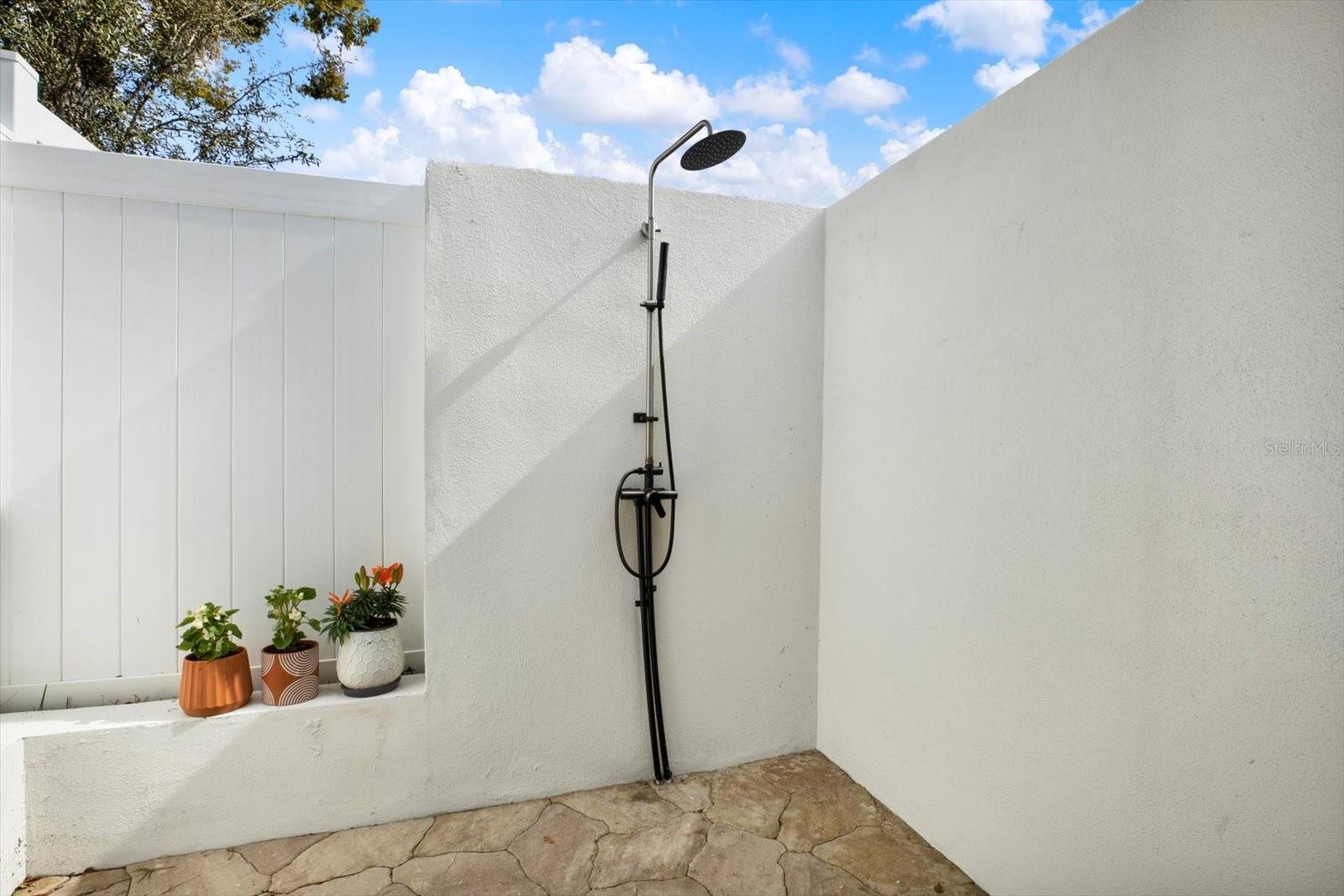 Outdoor shower outside of primary bathroom