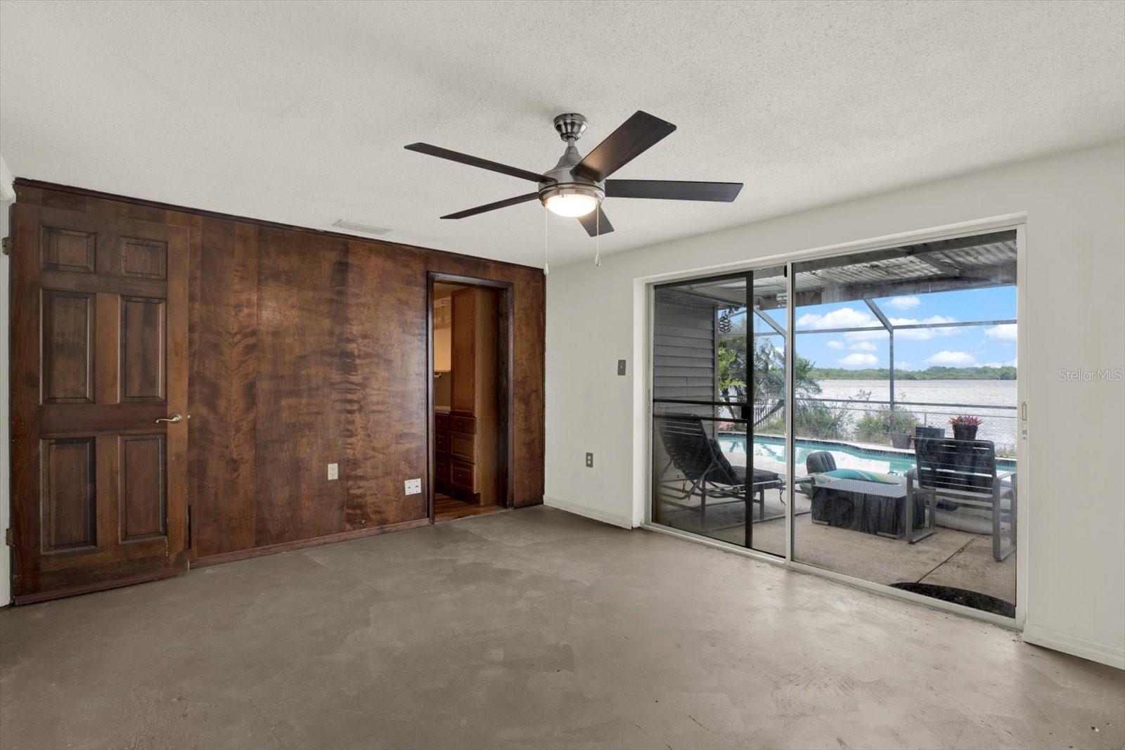 This primary suite includes a walk in closet, en suite & view to the private pool & lake