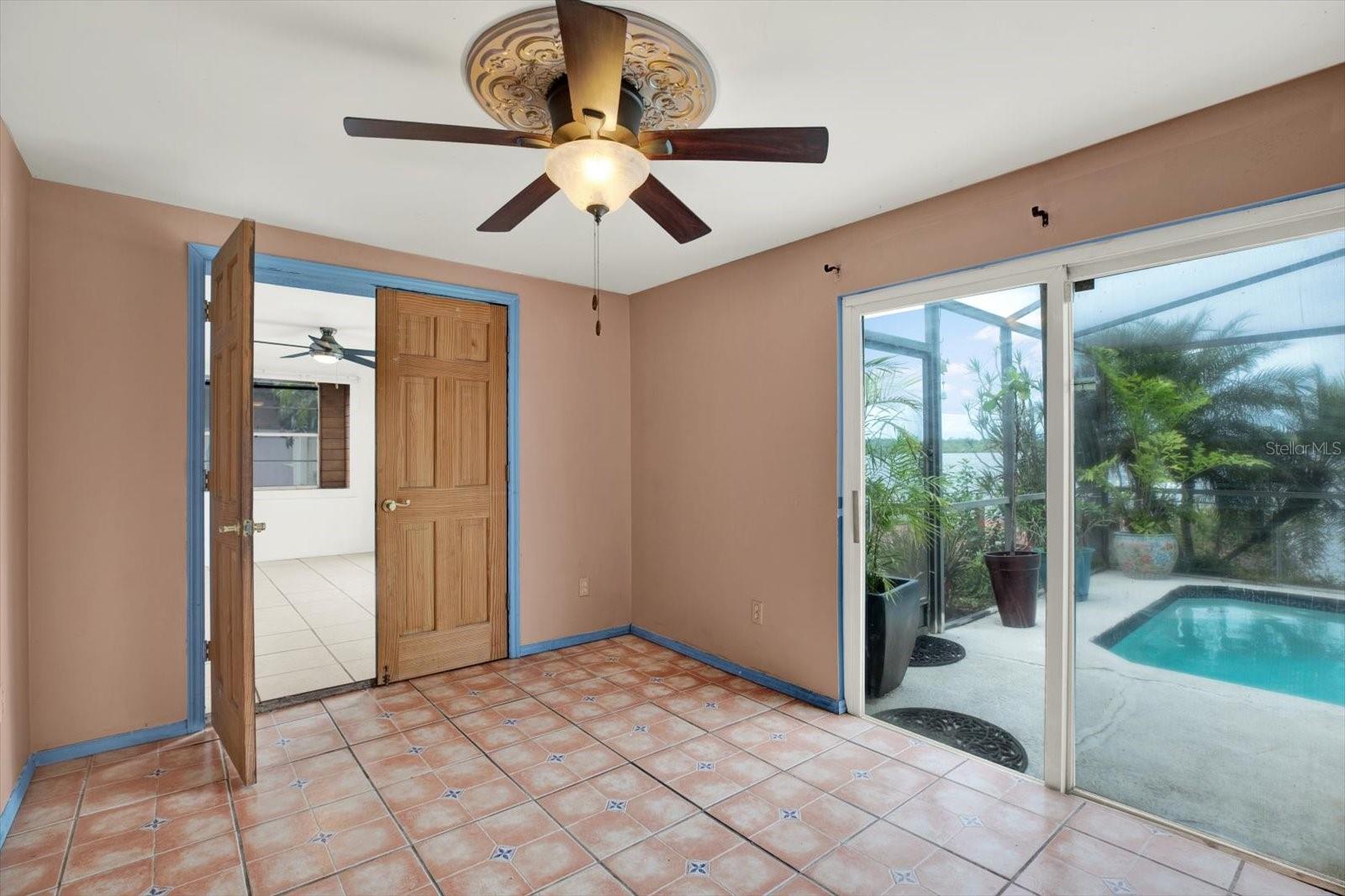 Bedroom in rear of home with access to the lanai. This is located off of the kitchen/dining area