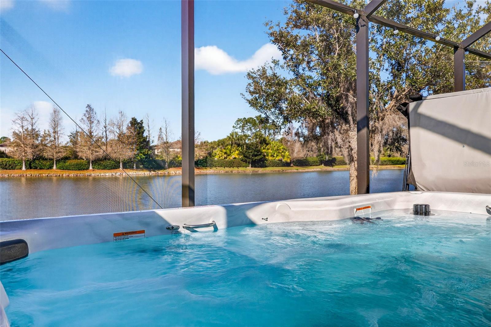 Relax in your swim spa while gazing out into the water.