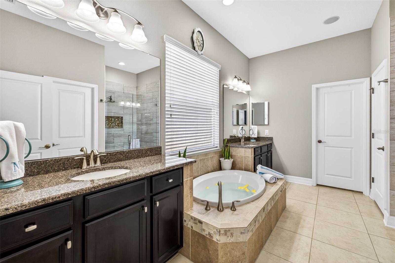 Ensuite bathroom in the primary suite - - soaking tub, walk in shower.