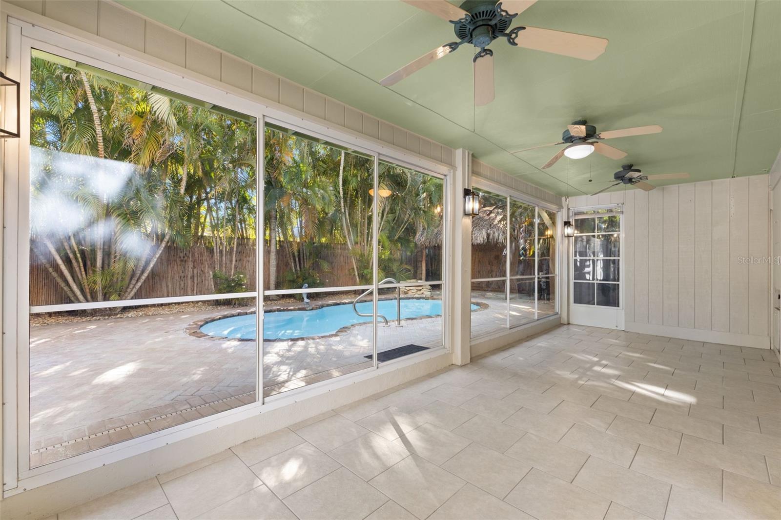 Back covered porch overlooking private backyard and pool.