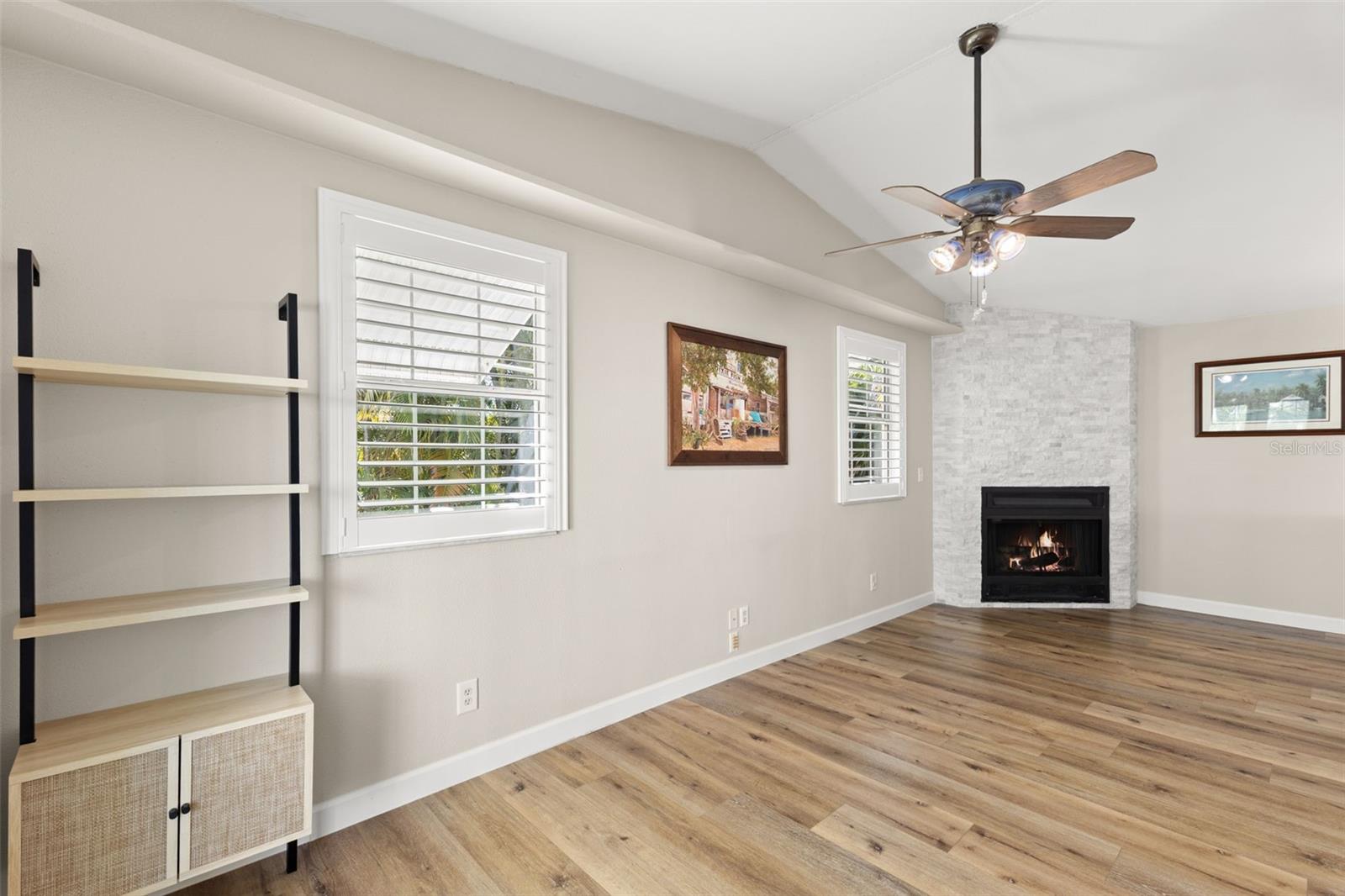 Family room/Office with stone covered wood burning fireplace.